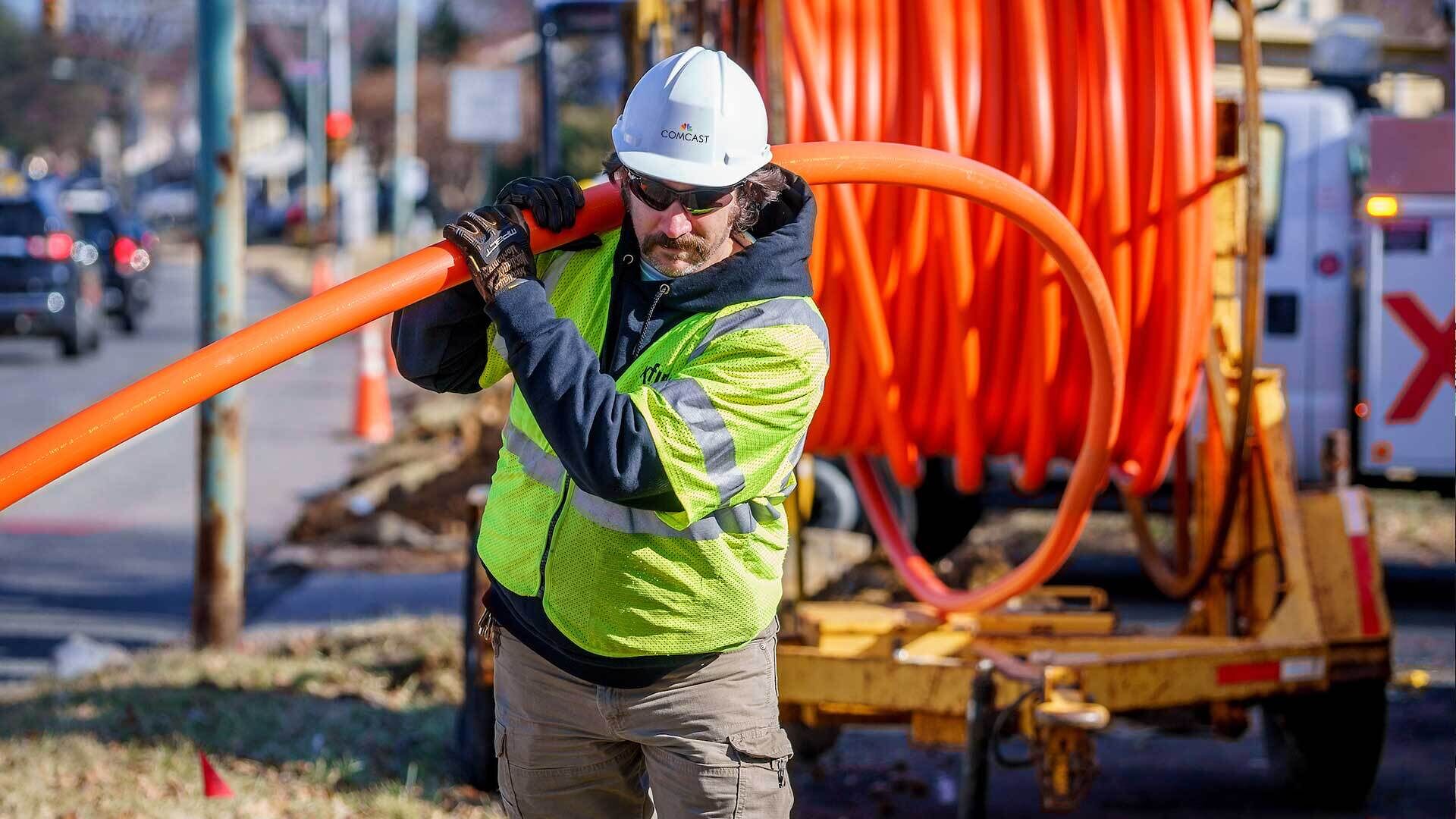 A technician carries a cable