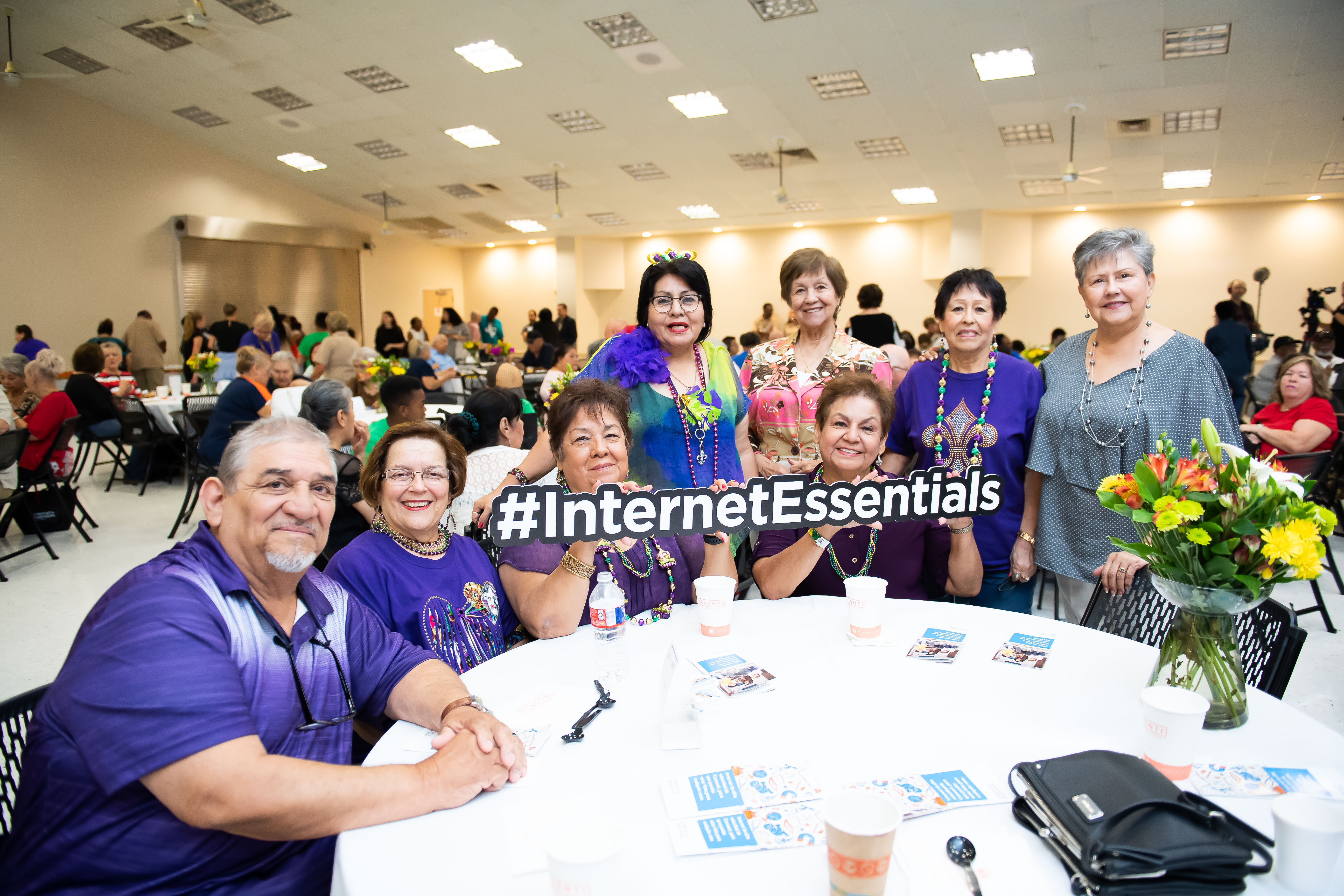 Seniors receive free laptops at an Internet Essentials event.