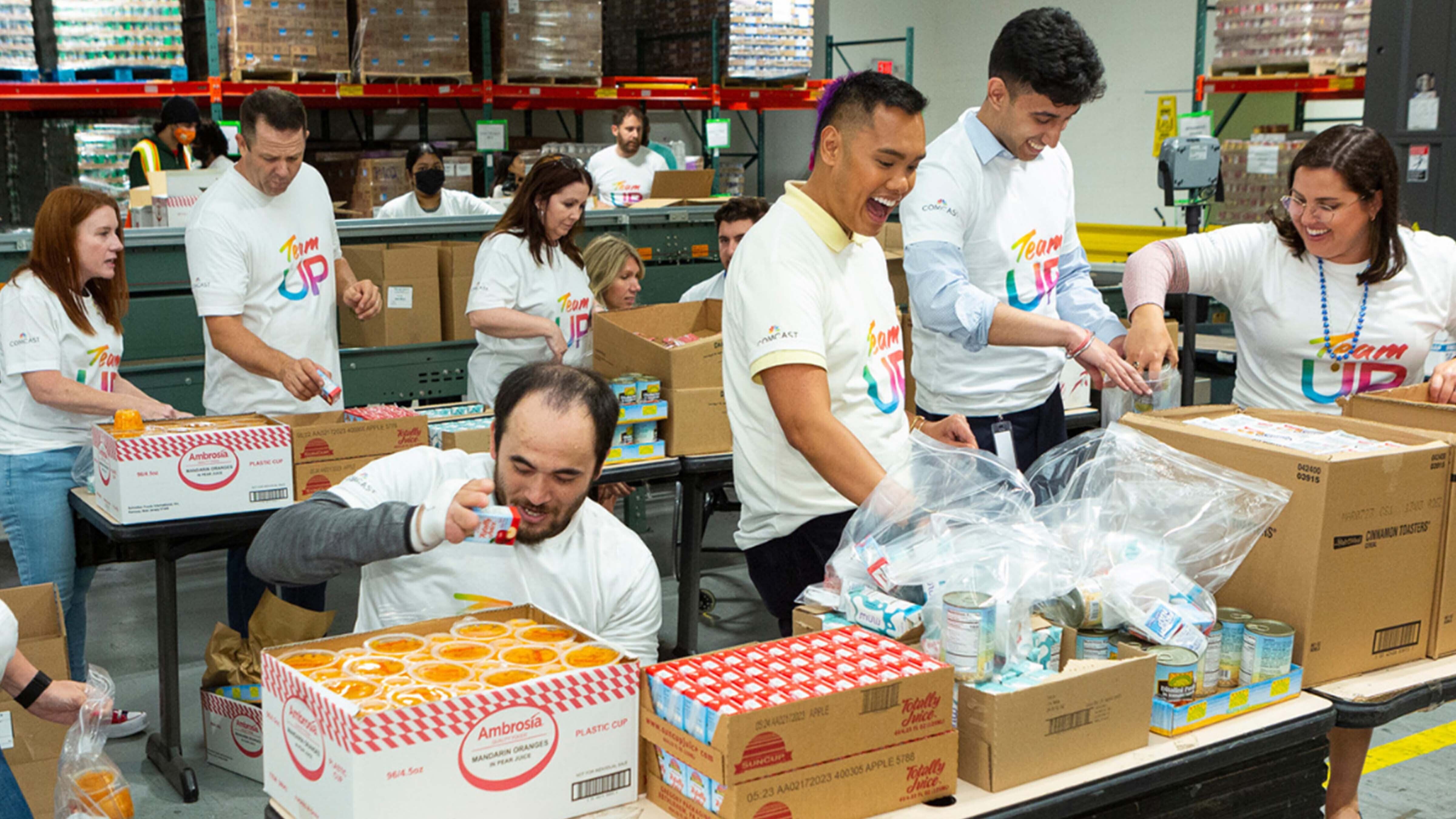 Team UP volunteers packaging food at a food bank.