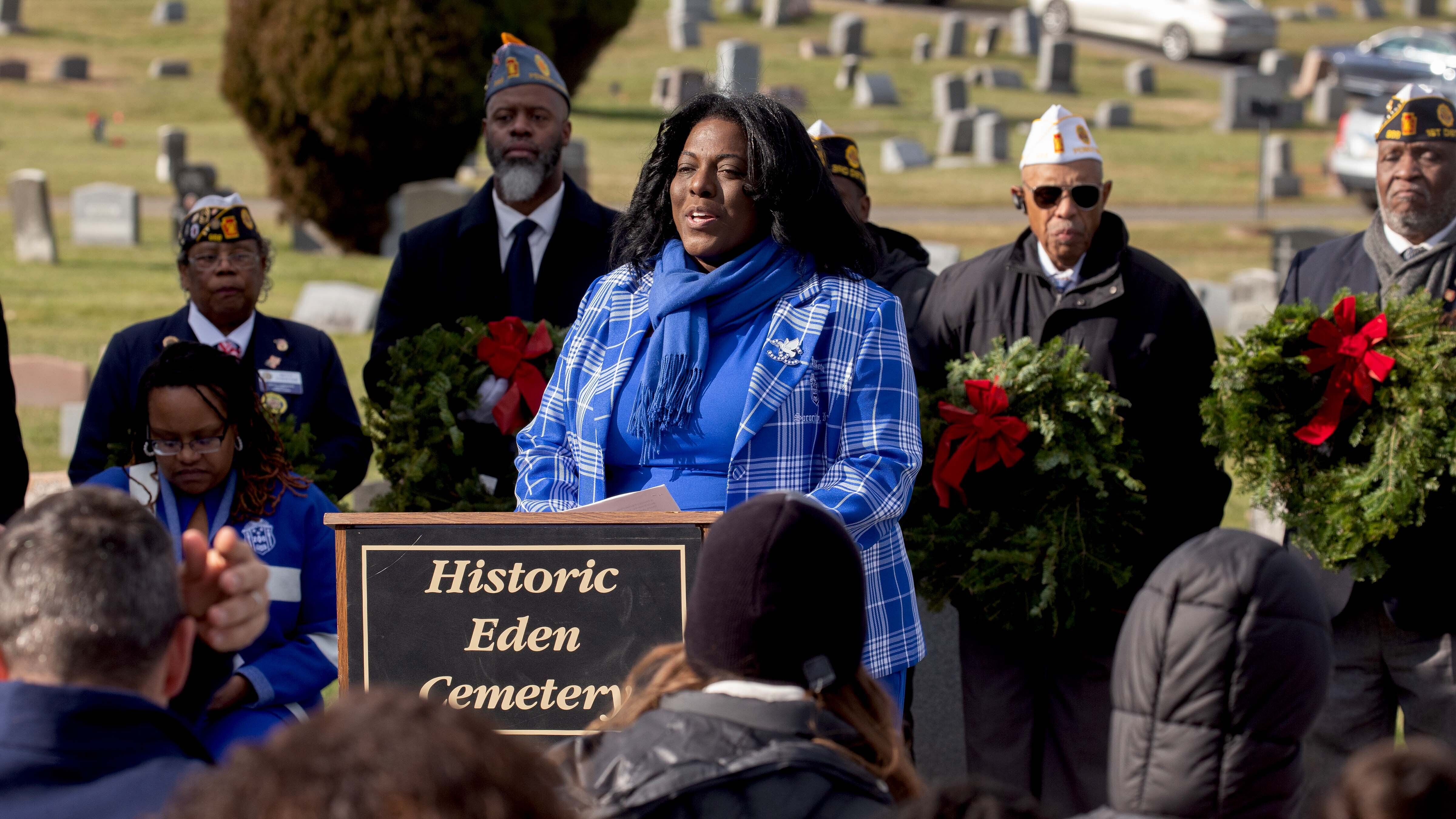 Speakers onstage at a Wreaths Across America event.