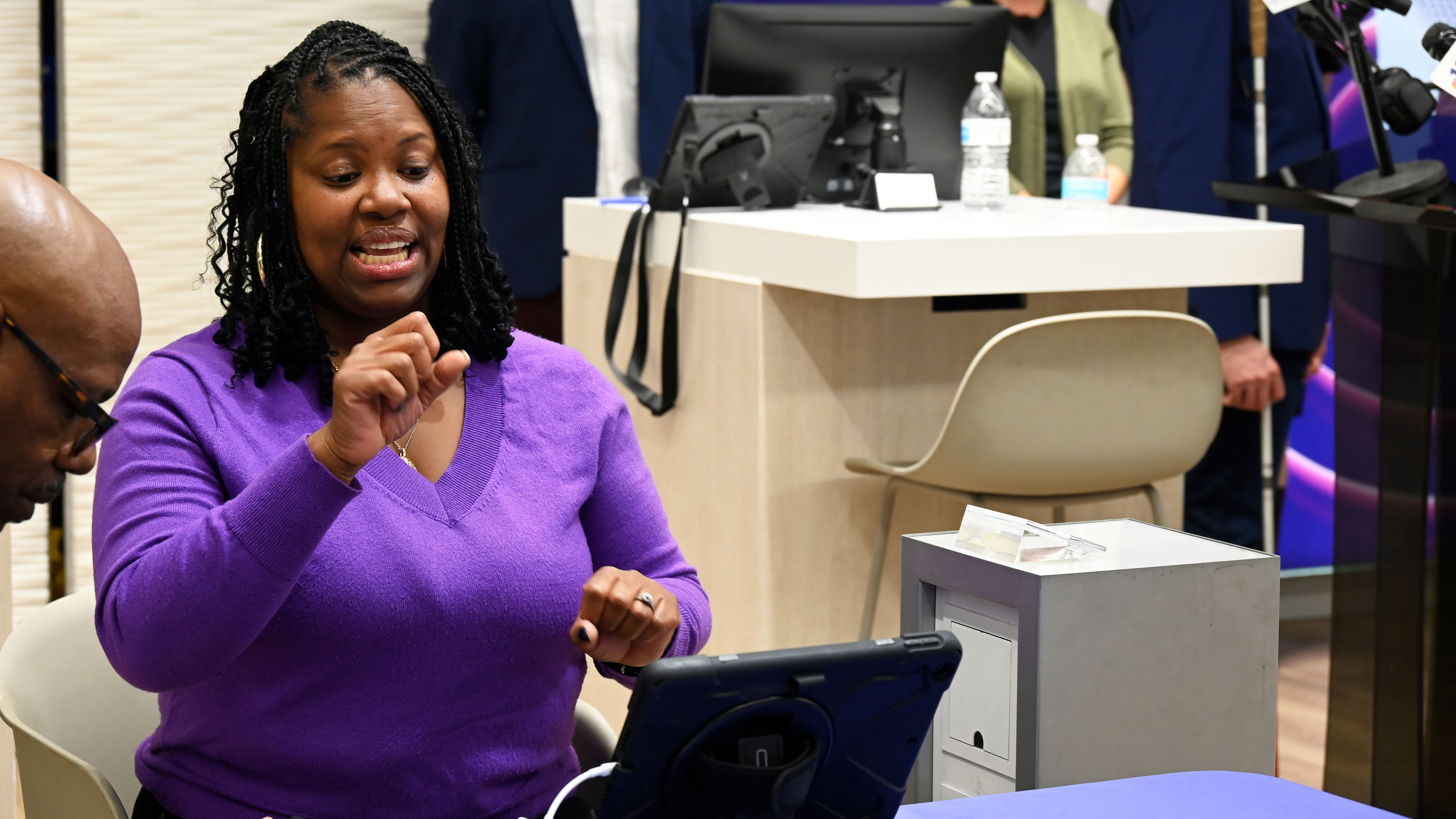 Xfinity customer, Alycia Brown, utilizes the ASL Video Remote Interpreting platform to communicate with a store associate during a demo at the City Avenue store in Philadelphia.