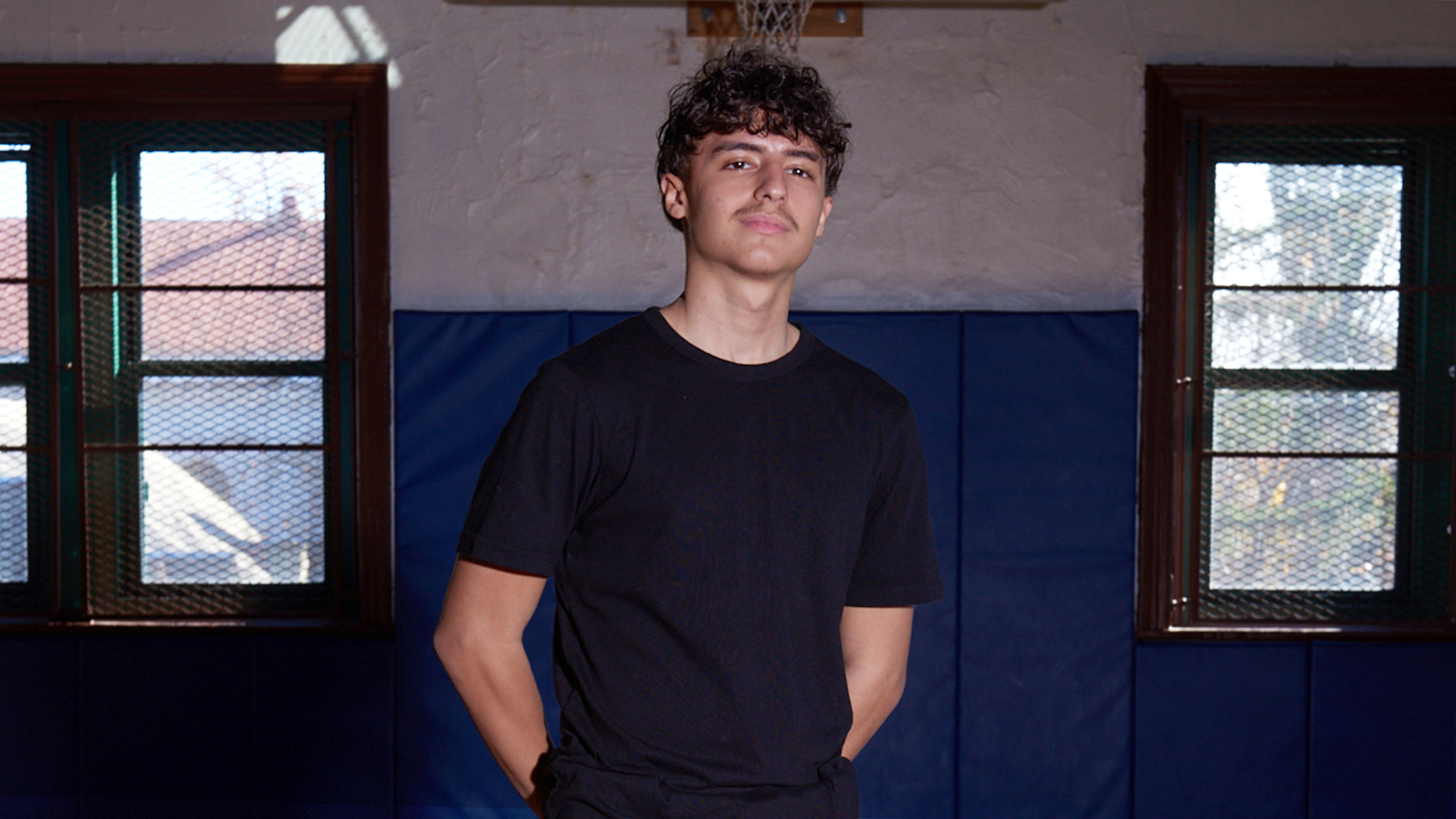 A student standing in a black shirt.