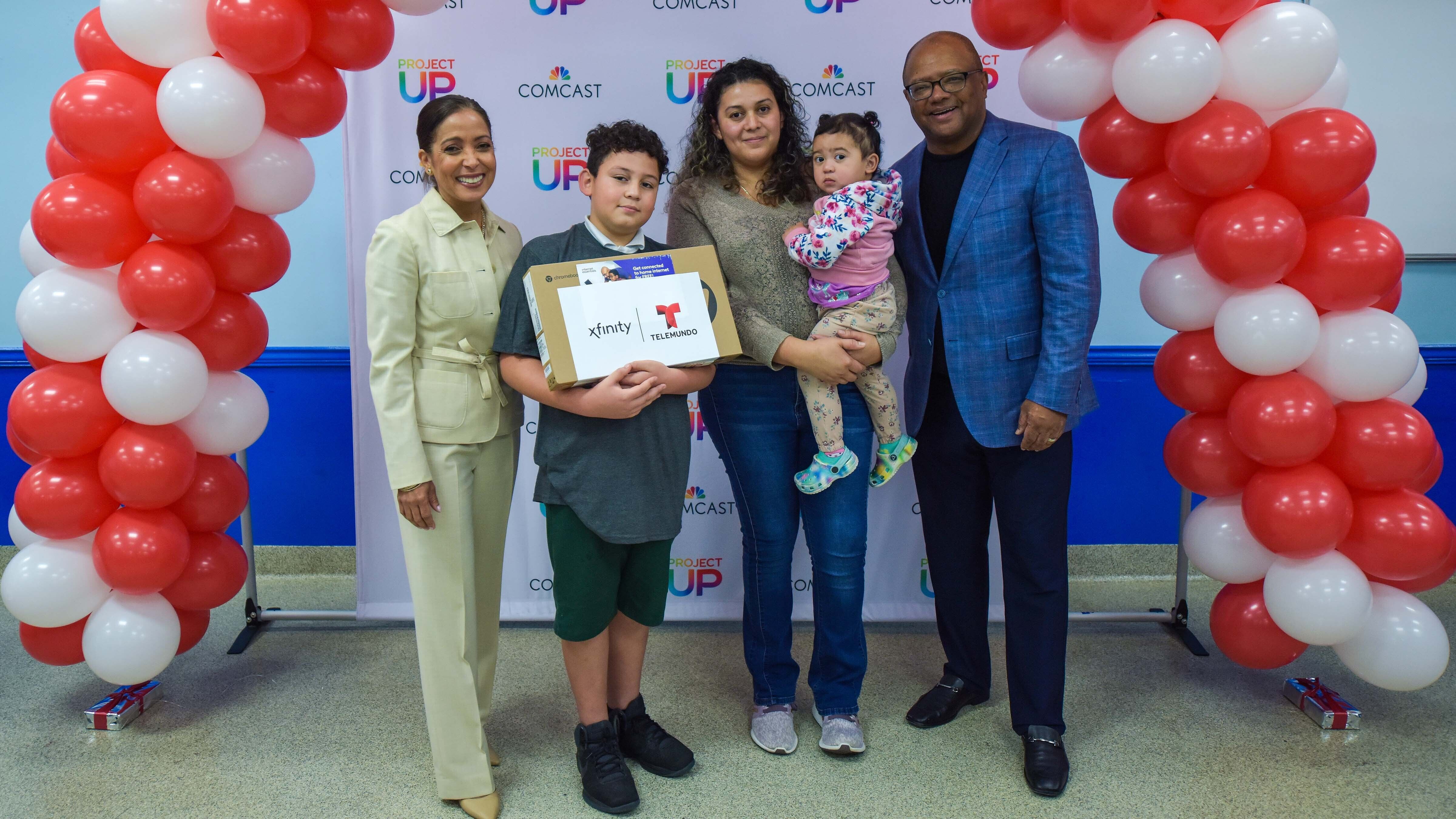 Fani, her son, Yariel, and her daughter with Broderick Johnson, Executive Vice President, Public Policy and Executive Vice President, Digital Equity, Comcast Corporation, and Christina Kolbjornsen, Se