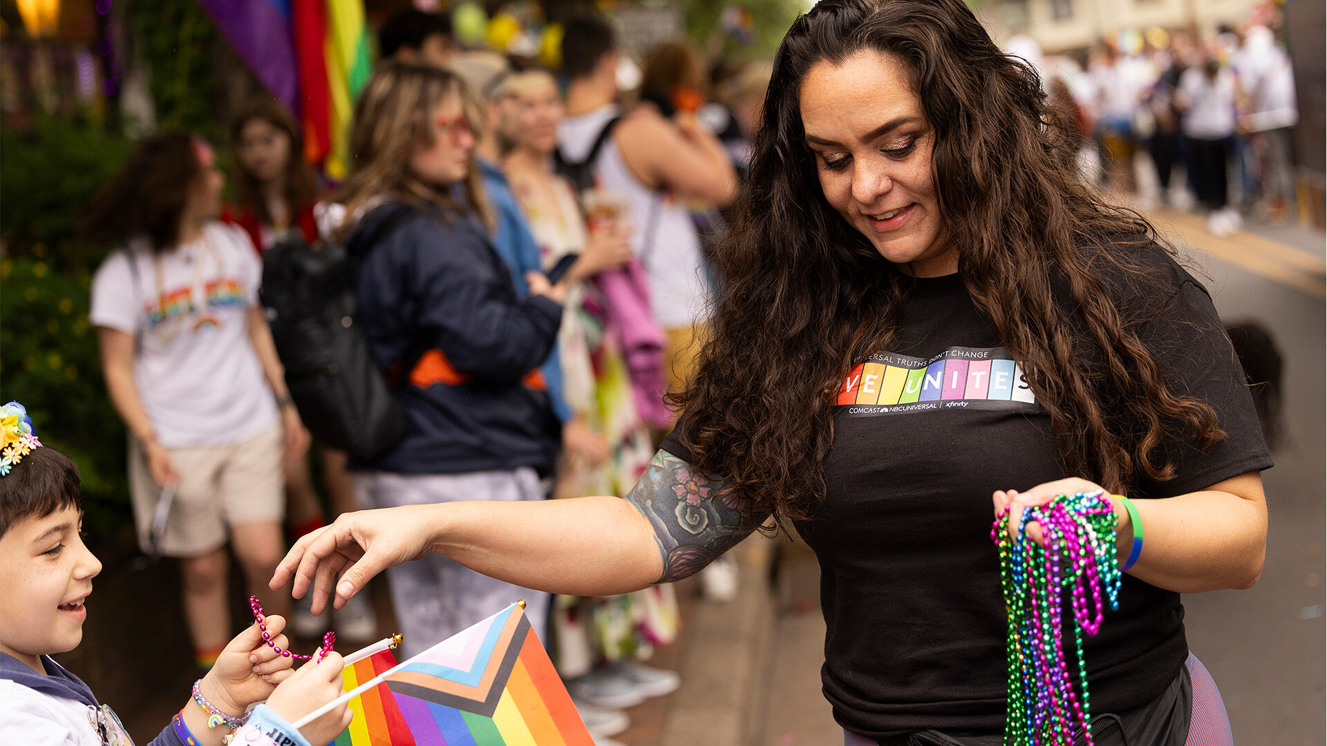 Pride parade participants holding up Pride flags.