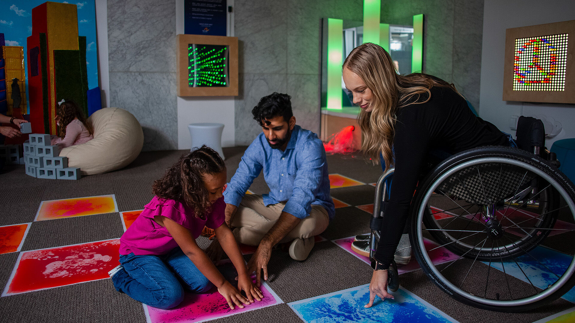 Liquid floor tiles change color with applied pressure to encourage sensory exploration and interactive games.